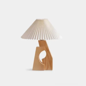 Modern pleated white fabric table lamp with natural wood base on plain white background, front view