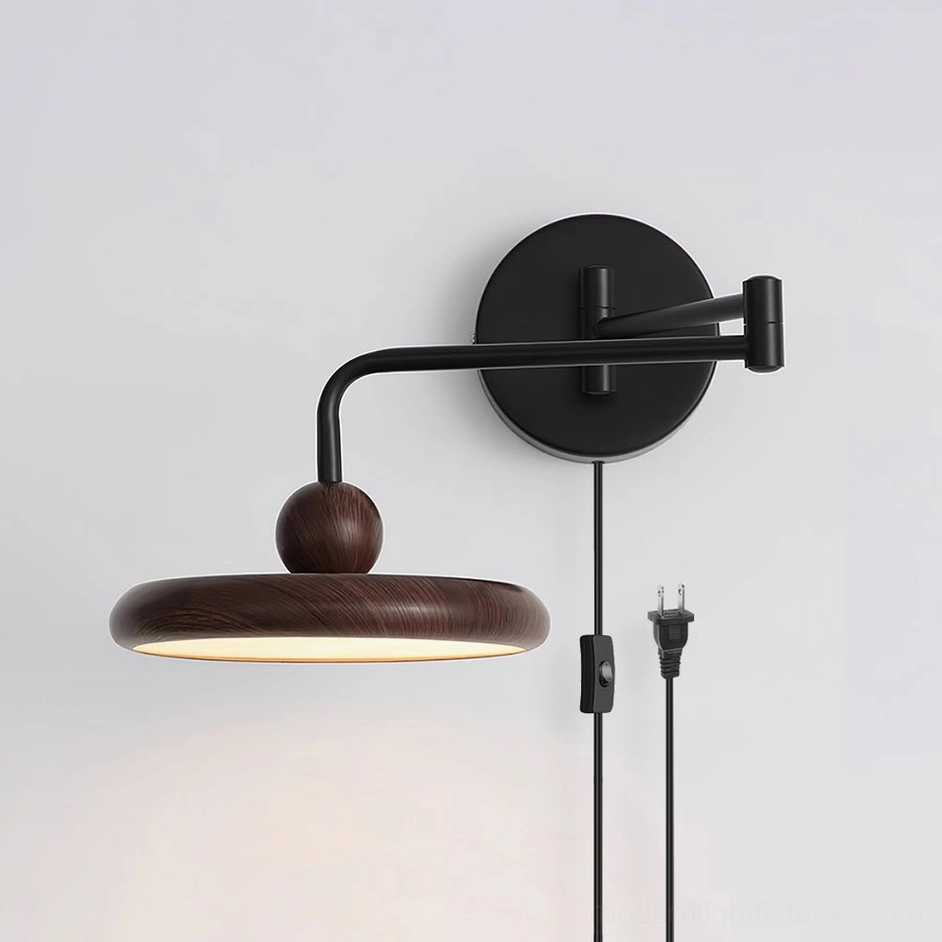Elegant plug-in wall lamp featuring matte black hardware, warm wood-grain shade, and integrated power switch in studio lighting