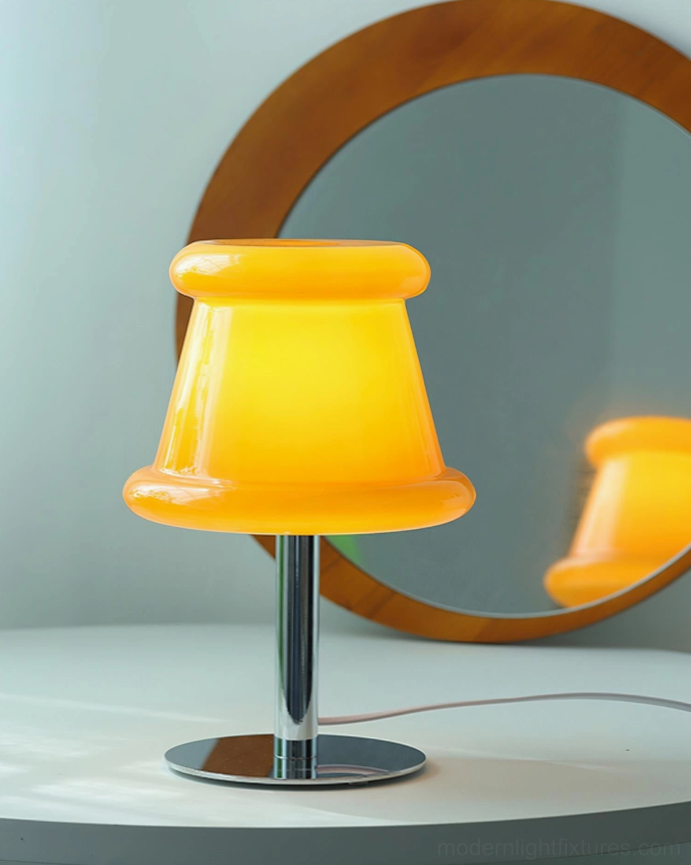 Modern pudding table lamp showcasing organic contemporary glass shade design with minimalist chrome base construction
