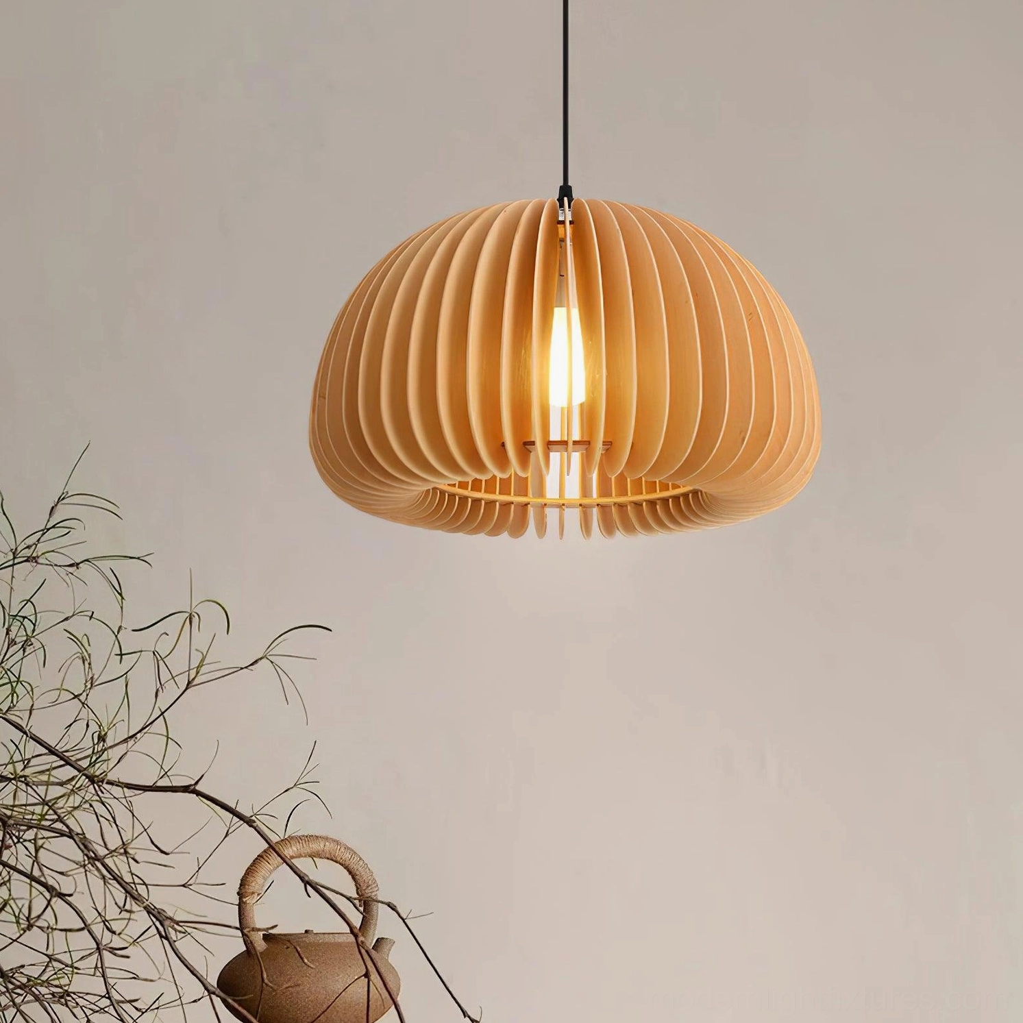 Handcrafted wood pumpkin pendant light in cozy home setting with dried flowers and wabi-sabi decor