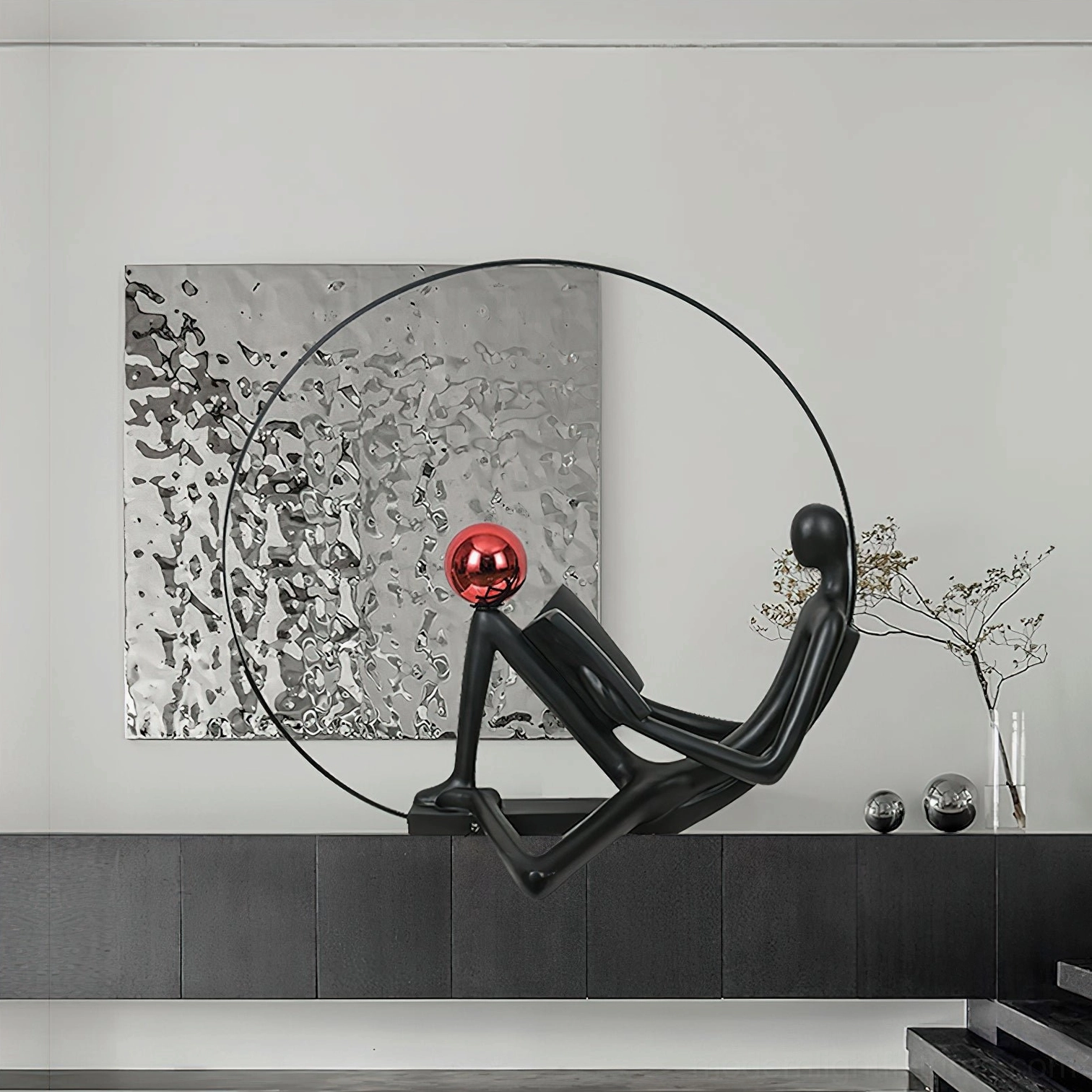 Minimalist reading figure floor lamp with glossy red sphere, contemporary interior with decorative metallic orbs and textured walls