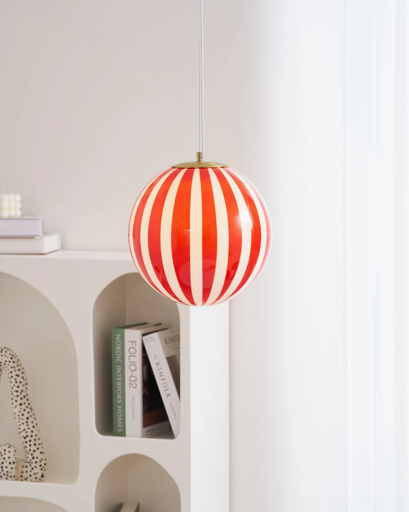 Modern red striped pendant light installation in transitional interior design space