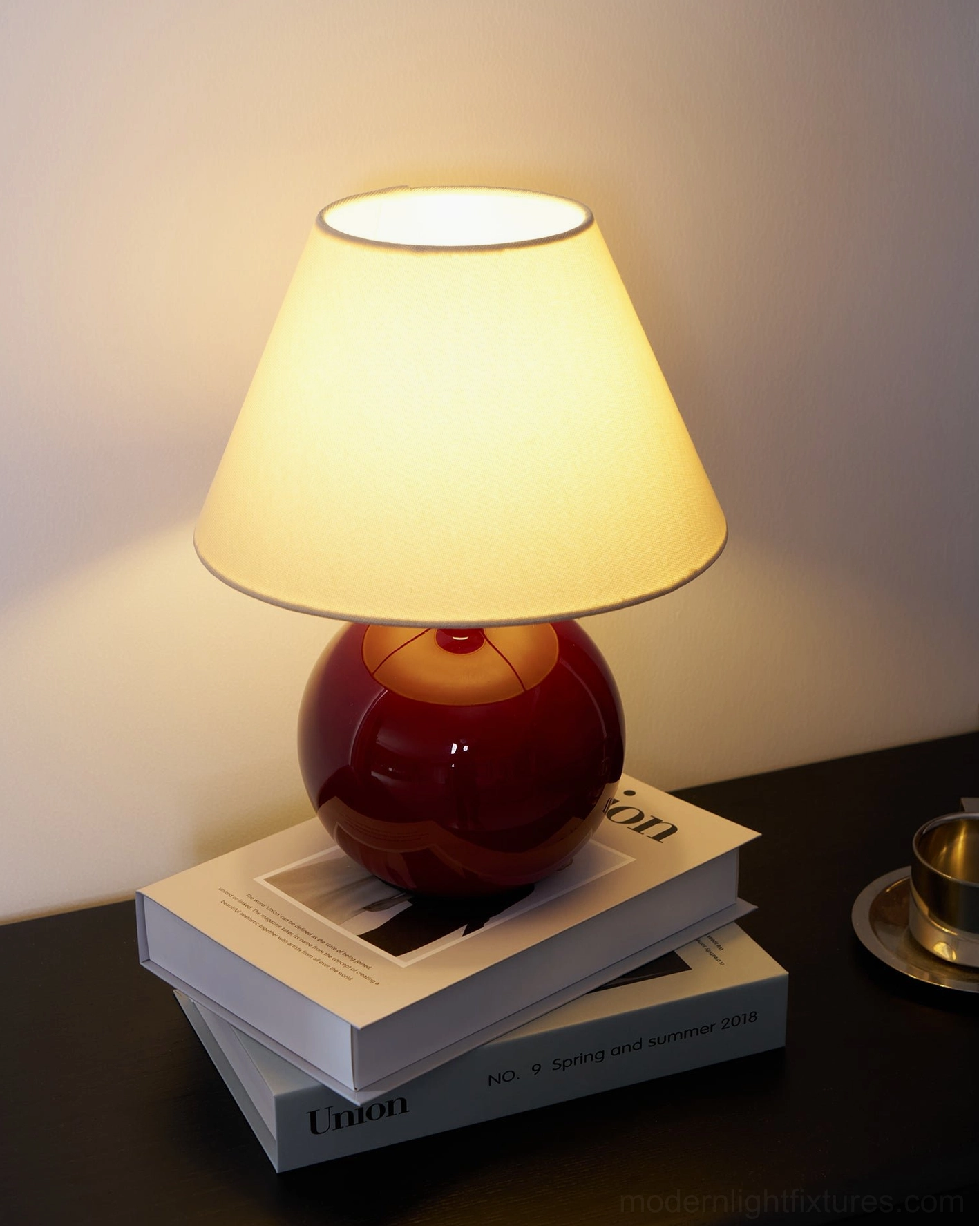 Modern red spherical table lamp in contemporary bedroom interior design setting