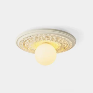 Modern resin ceiling light with floral geometric carved design and frosted acrylic globe, front studio view