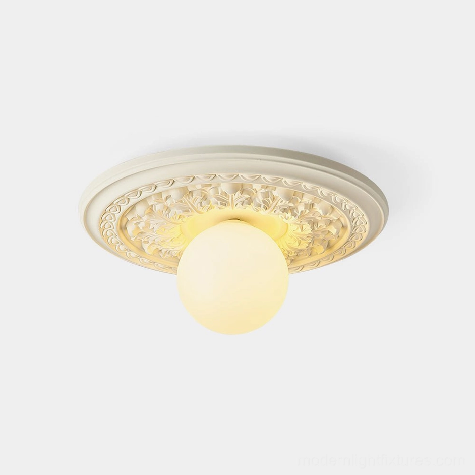 Modern resin ceiling light with floral geometric carved design and frosted acrylic globe, front studio view