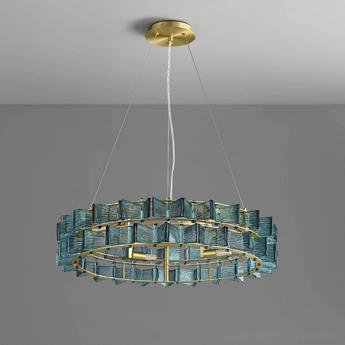Contemporary ring chandelier teal glass and brass frame angled left view in studio lighting
