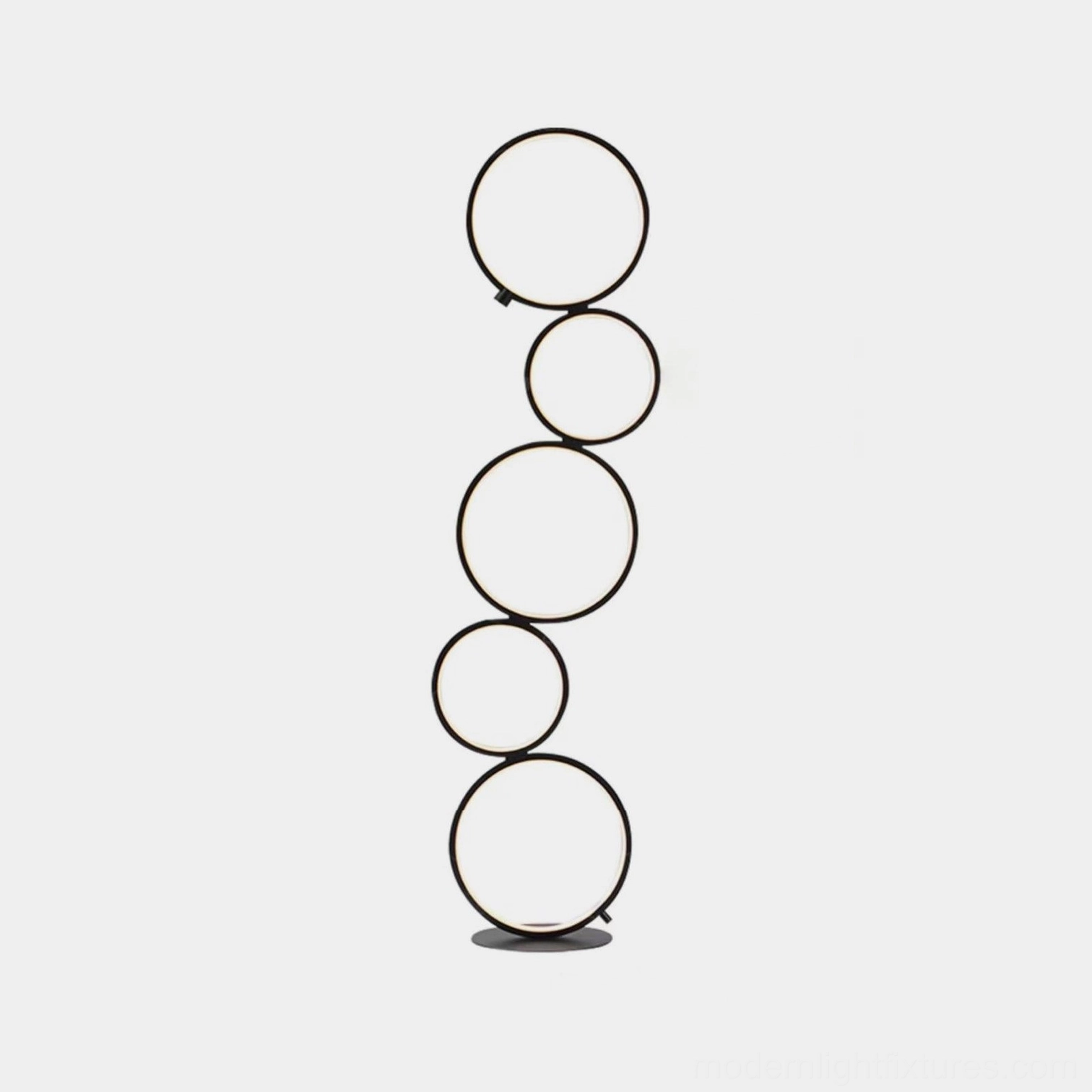 Modern minimalist ring floor lamp with matte black finish on white studio backdrop, showcasing sleek circular LED design
