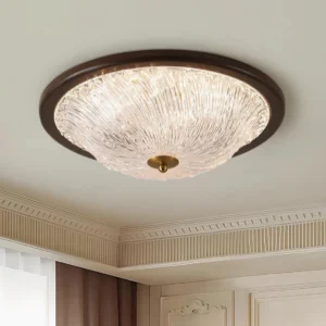 Lit modern ceiling light fixture installed in classic bedroom with crown molding - warm white 3000K ambient glow