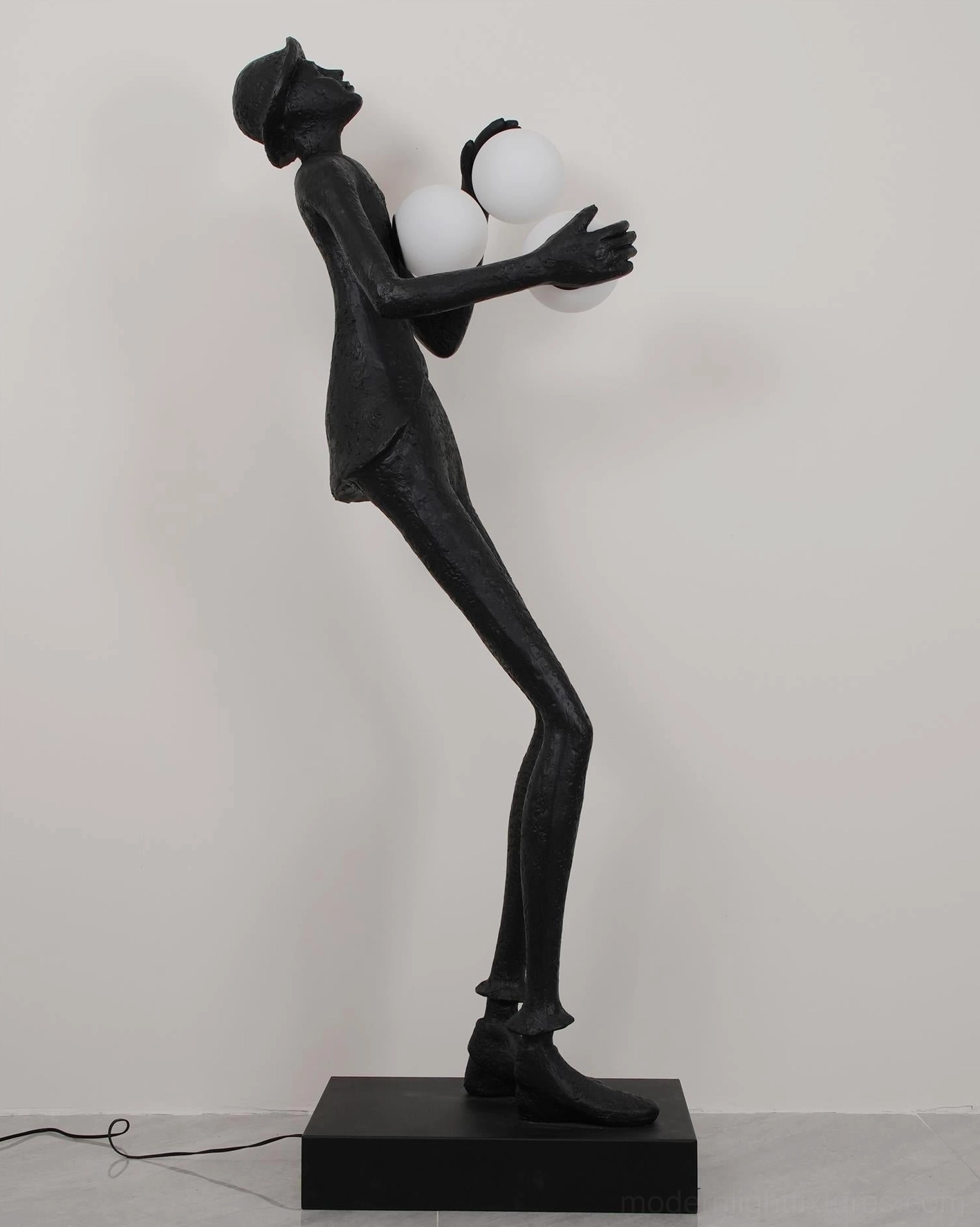 Modern black humanoid sculptural floor lamp textured finish with frosted glass sphere lighting