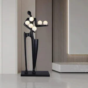 Contemporary art floor lamp three-quarter front view showcasing resin humanoid sculpture with extended arms, square metal base