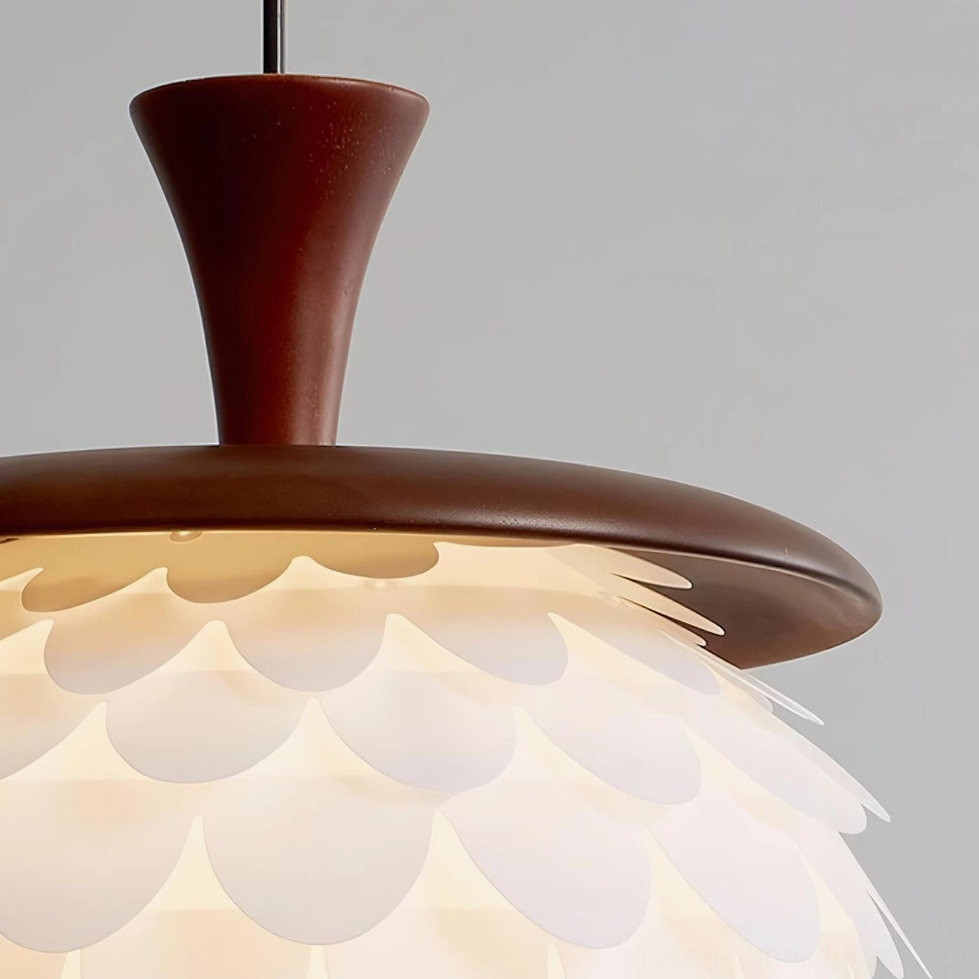 Modern sculptural pendant light with organic petal design creating ambient warm white lighting in contemporary home interior