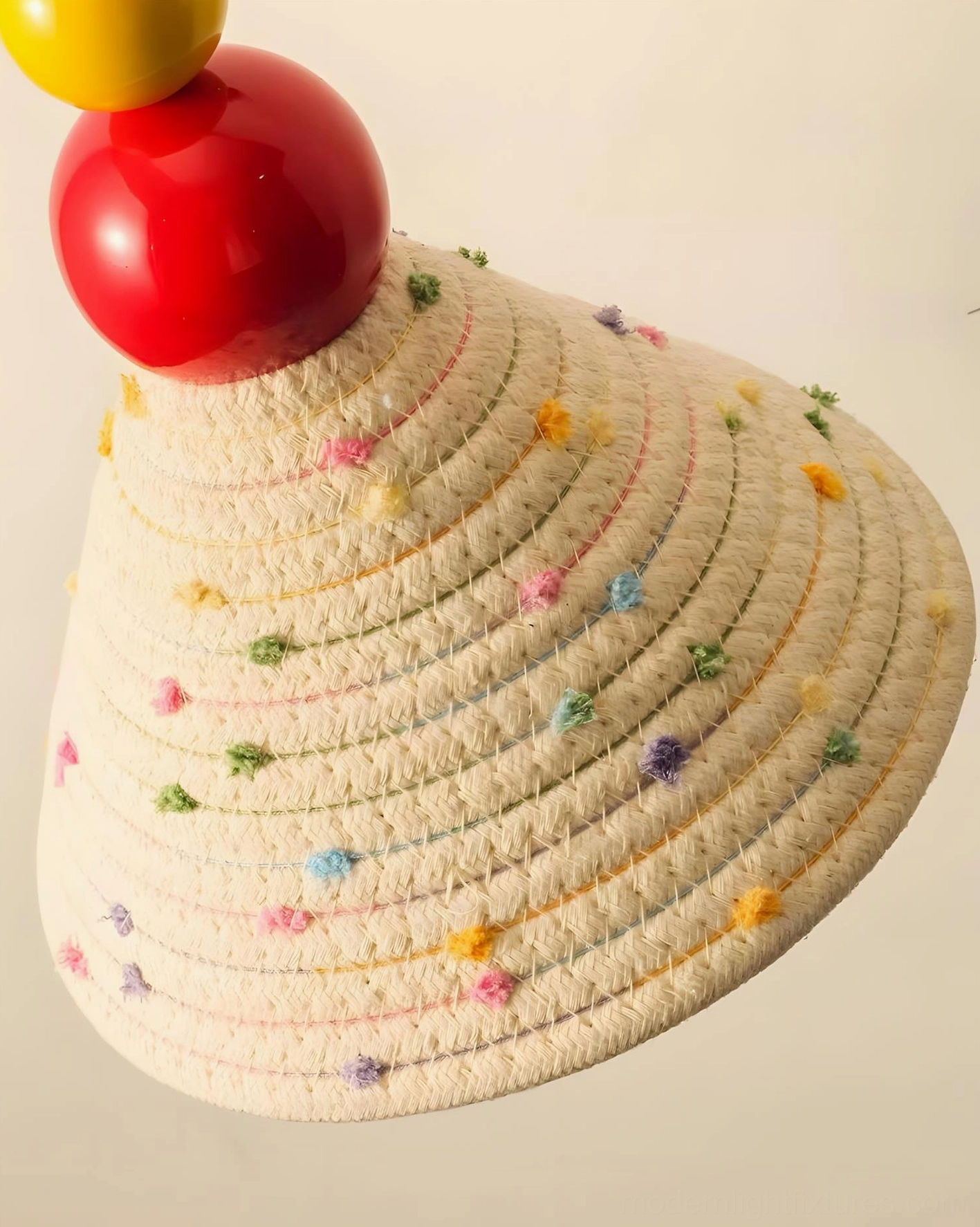 Modern handwoven wall sconce with sculptural charm and playful color accents in residential environment