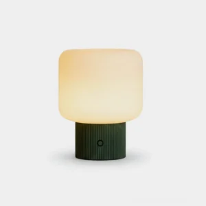 Modern sphere table lamp with frosted glass shade and dark green ribbed base, front studio view