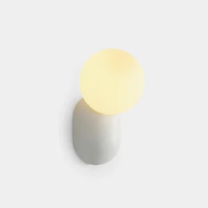 Modern minimalist spherical wall sconce with cantilever arm, matte resin body and frosted glass diffuser in studio shot
