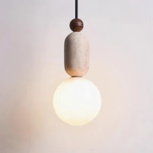 Close-up detail of minimalist pendant light showing natural travertine texture and material composition