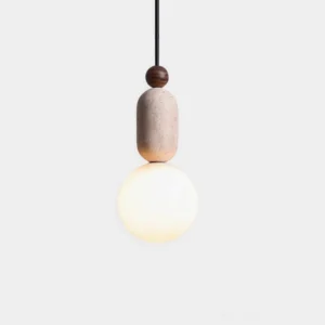 Modern stacked pendant light with walnut wood sphere, textured travertine cylinder, and glass orb - front studio view