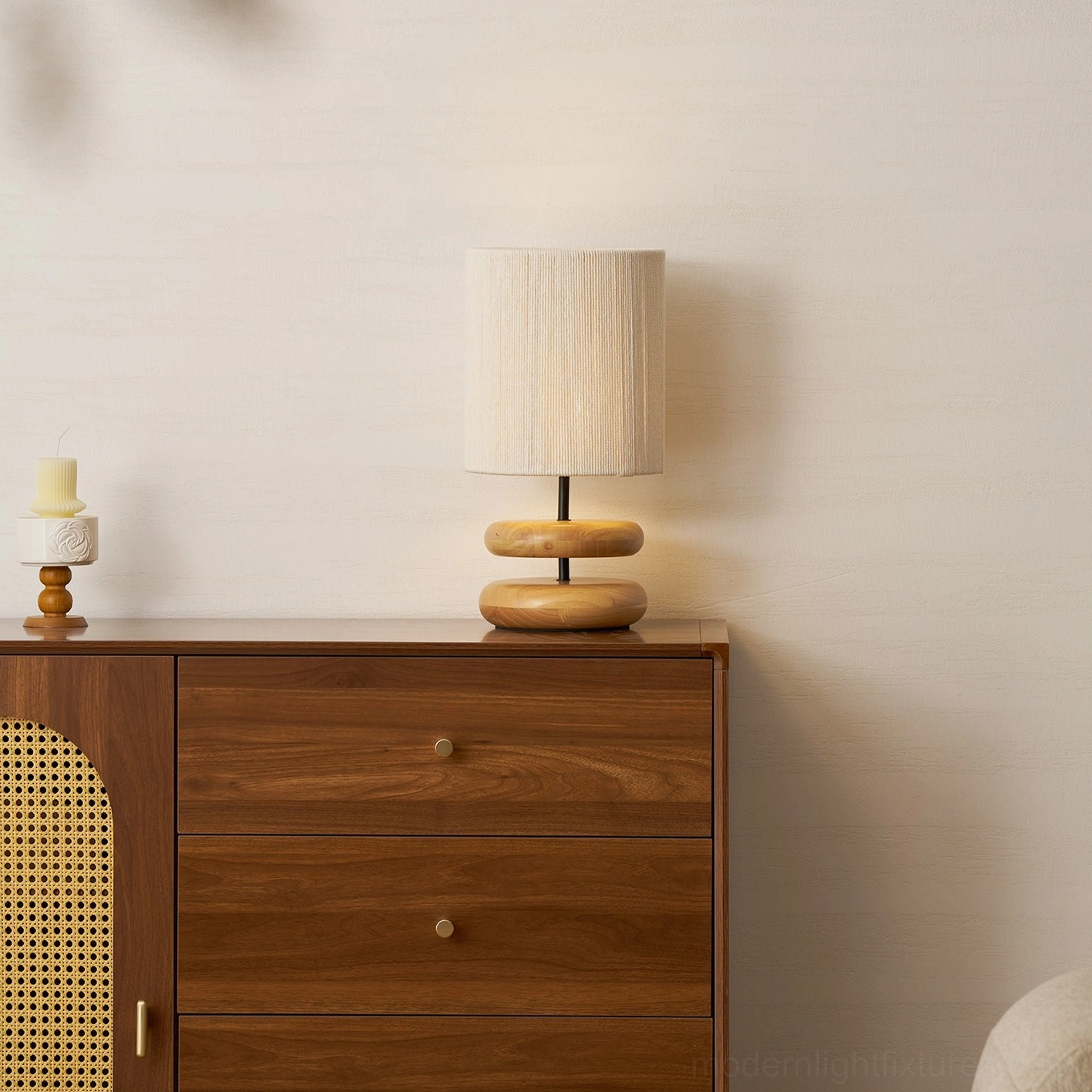 Modern stacked wood lamp providing warm lighting in minimalist interior space
