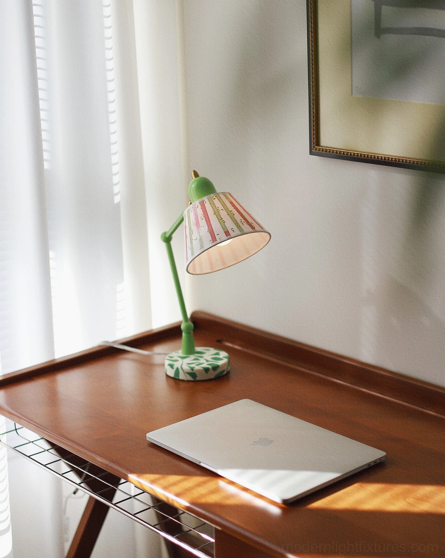 Modern swing arm desk lamp with green metal frame and vibrant striped fabric shade, full product display