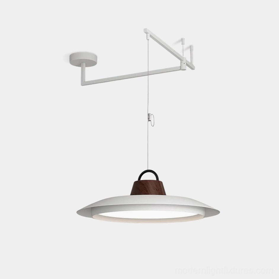 Swing arm pendant light with white metal frame and walnut wood accent, disc-shaped shade studio view
