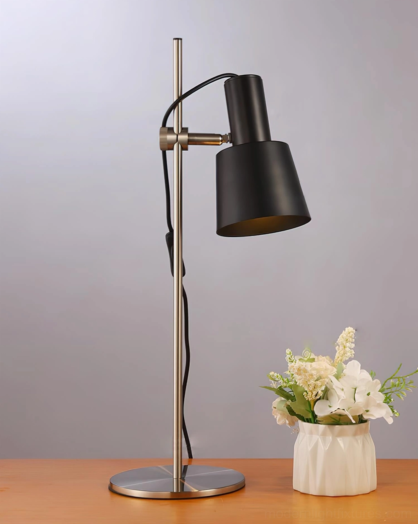 Modern adjustable metal table lamp with nickel finish and adjustable orange shade for minimalist interiors