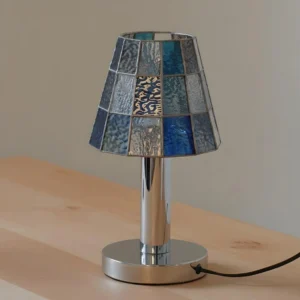 Blue stained glass mosaic table lamp with polished chrome metal stand, three-quarter view