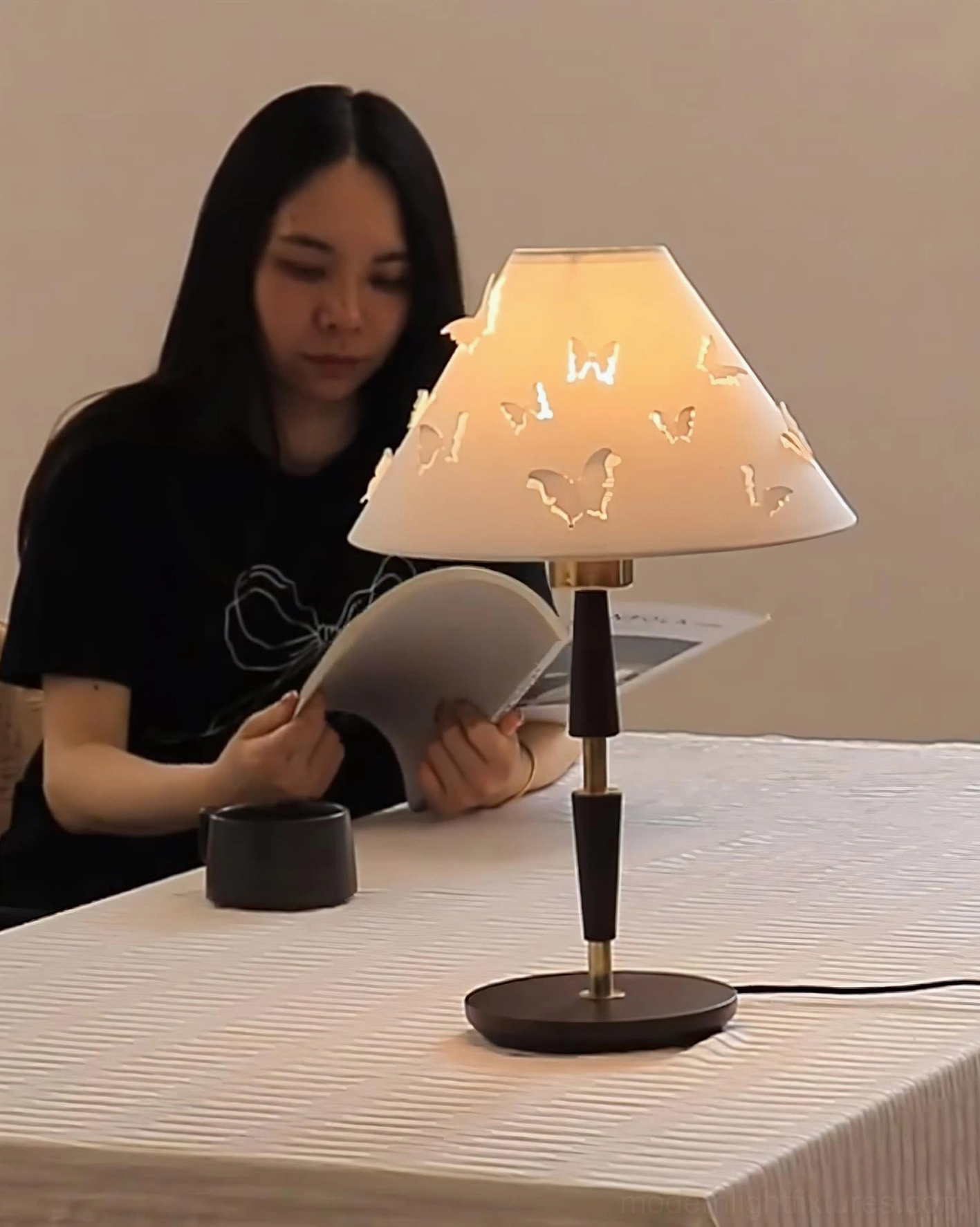 Butterfly perforated table lamp on home office desk with warm task lighting for reading and work
