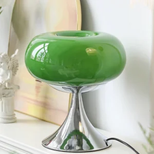 Contemporary lollipop LED table lamp displayed on decorative shelf with art objects and figurines
