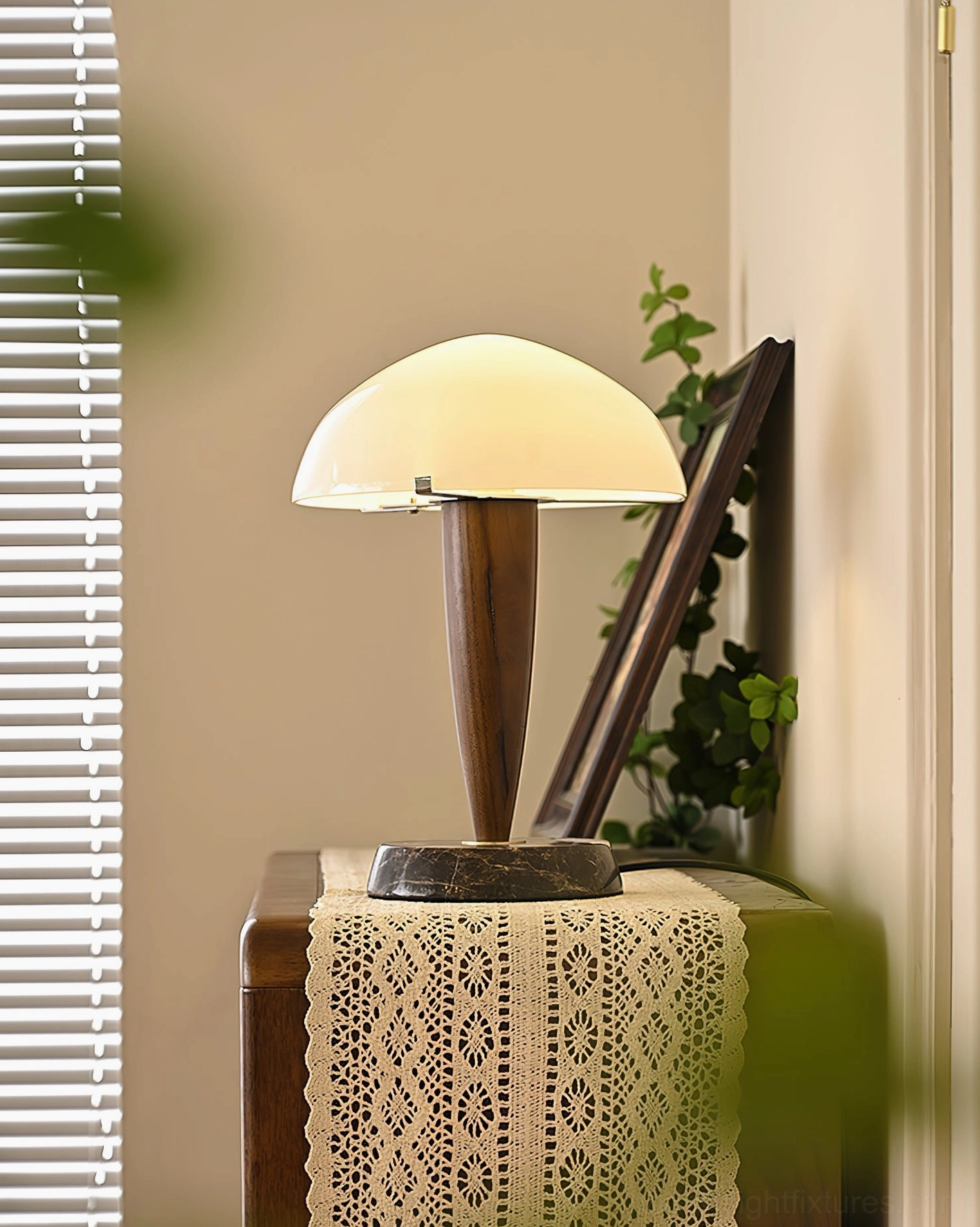 Tibby table lamp styled in interior design setting on wooden cabinet with lace table runner and decorative accents - three-quarter view