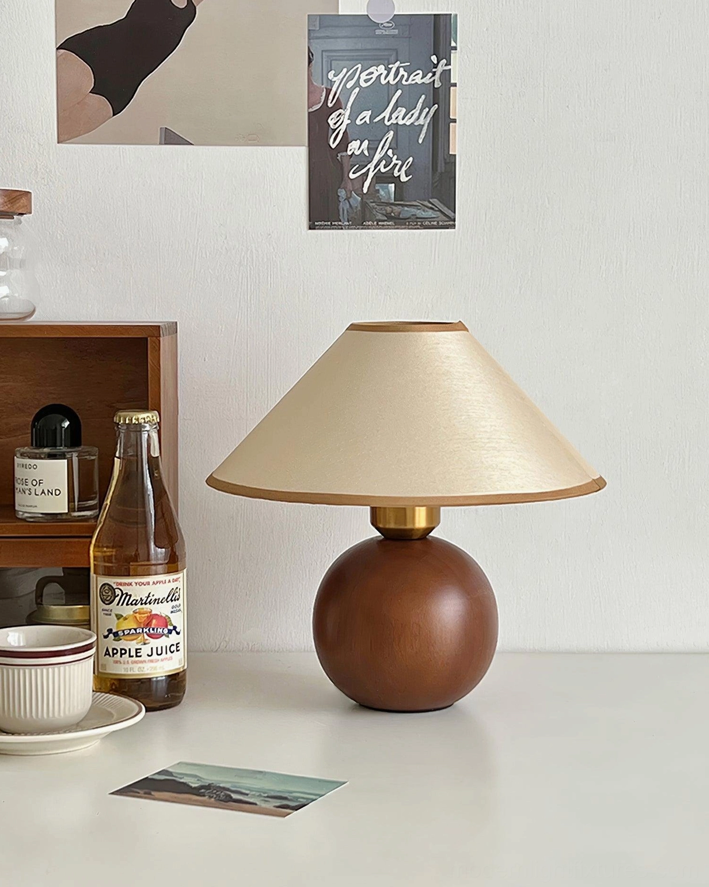 Modern table lamp with walnut wood base and beige fabric shade, three-quarter view product display