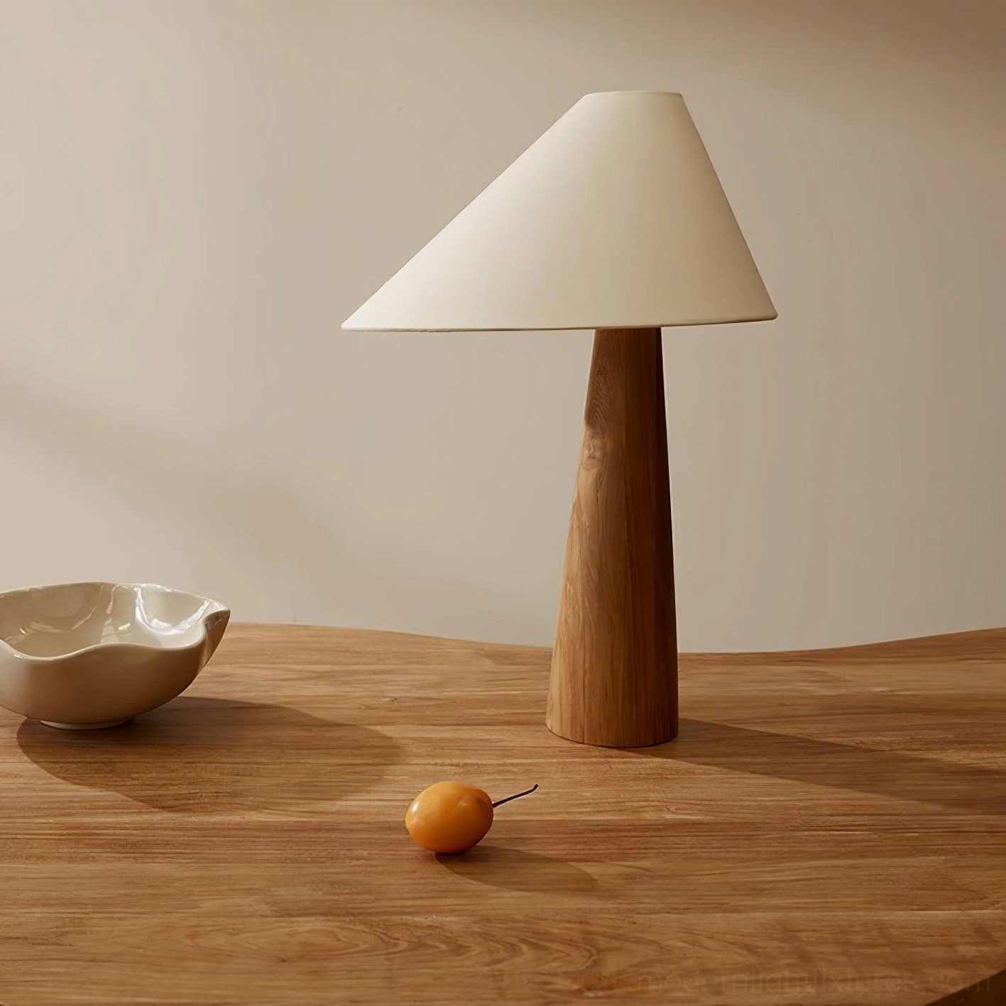 Modern Alvin table lamp positioned on wooden dining table in minimalist Scandinavian interior setting