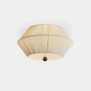 Modern tapered fabric flush mount ceiling light with warm beige drum shade and dark spherical finial, studio overhead view