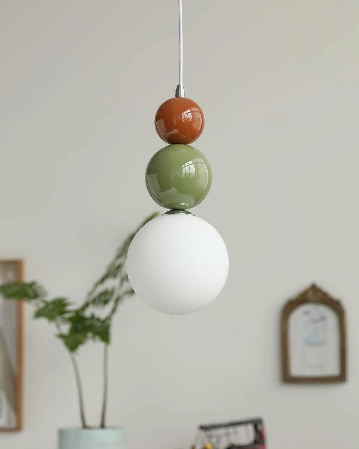 Modern three-sphere pendant light installed in stylish interior design composition