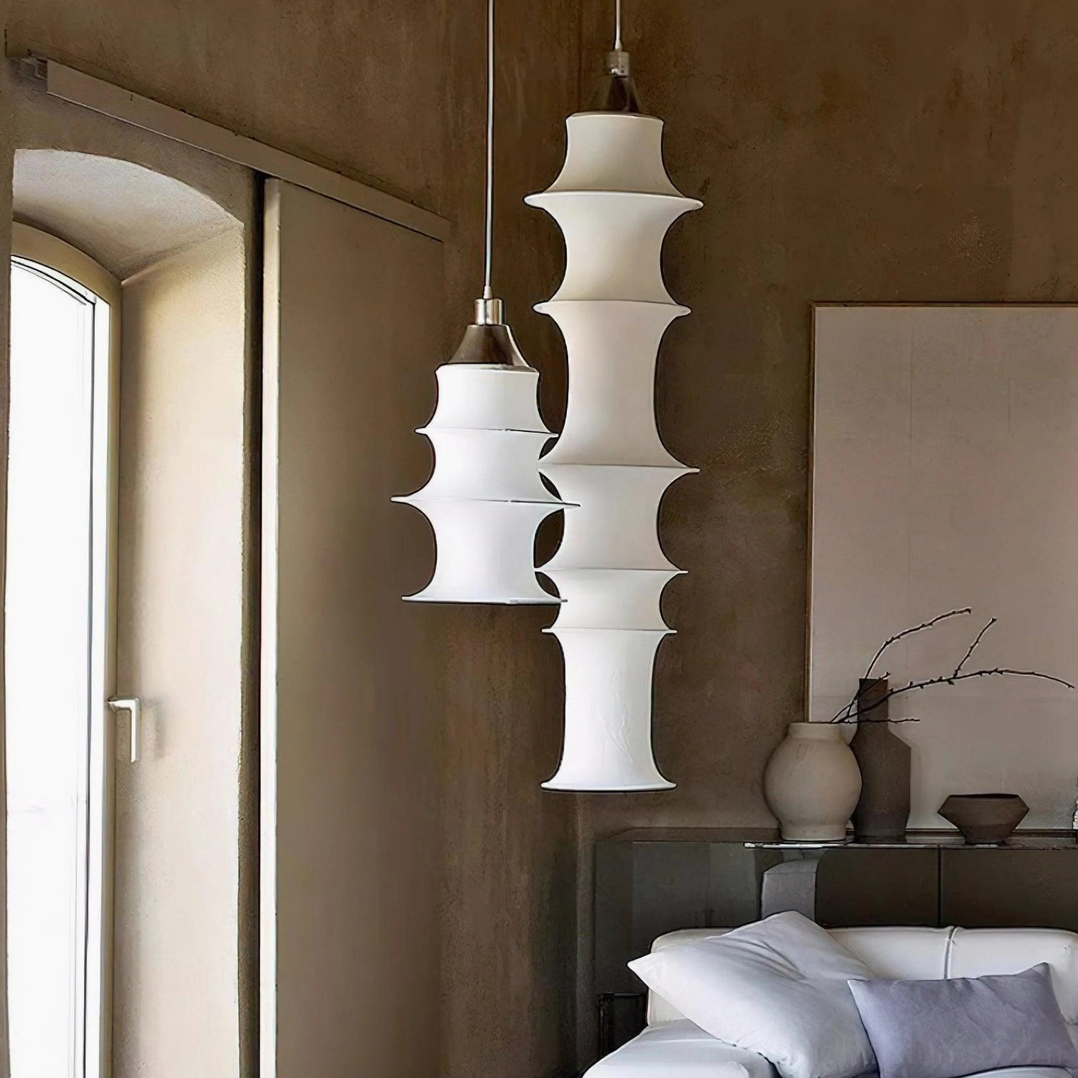Modern tiered white pendant light in Scandinavian home with minimalist furnishings