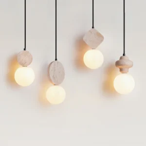 Multiple Cenari sculptural pendant lamps with irregular stone bases and glowing frosted glass shades on white backdrop