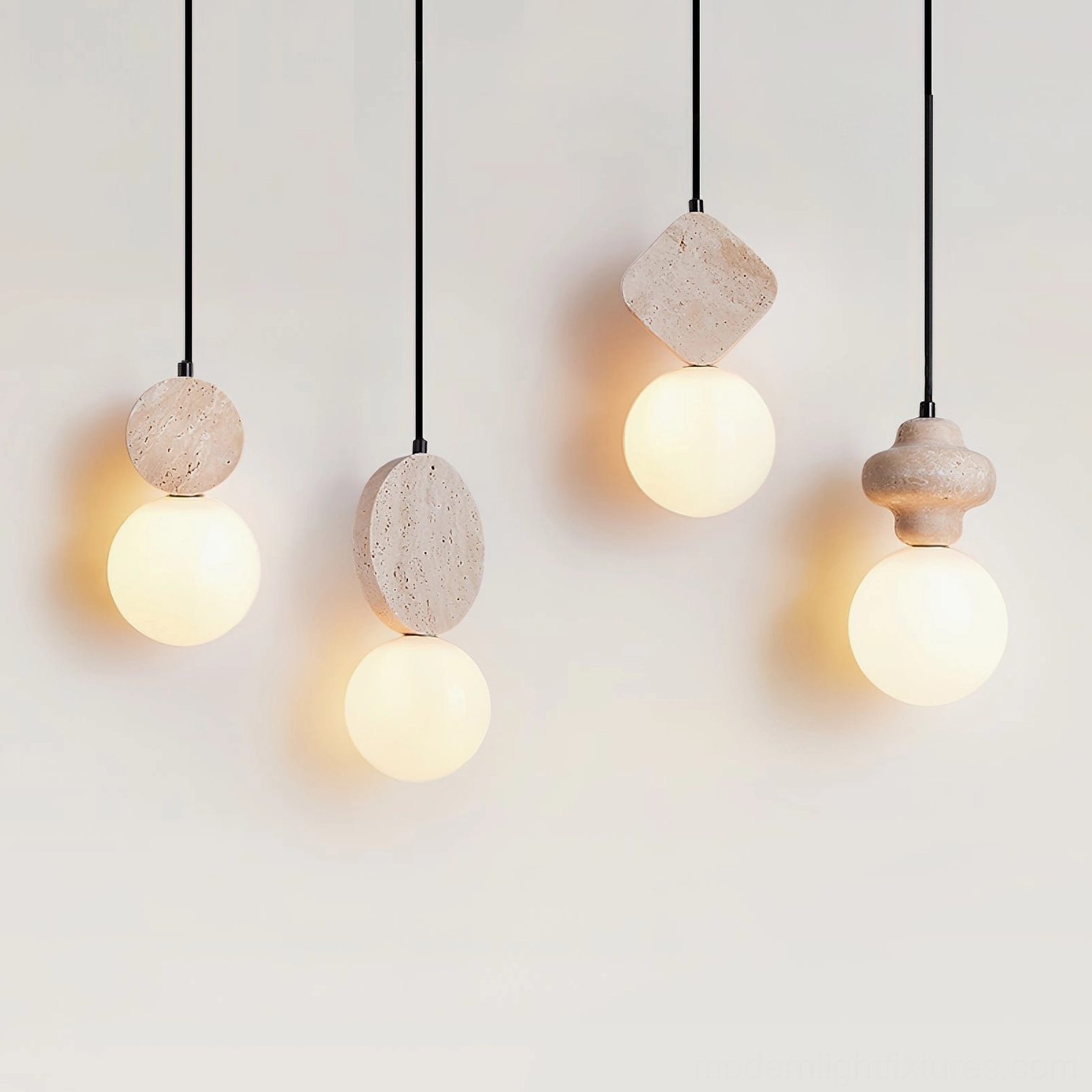 Multiple Cenari sculptural pendant lamps with irregular stone bases and glowing frosted glass shades on white backdrop
