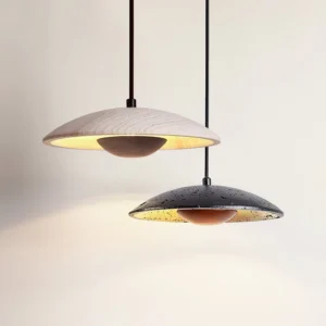 Two Orvian pendant lights side by side in beige and black travertine showcasing color variants