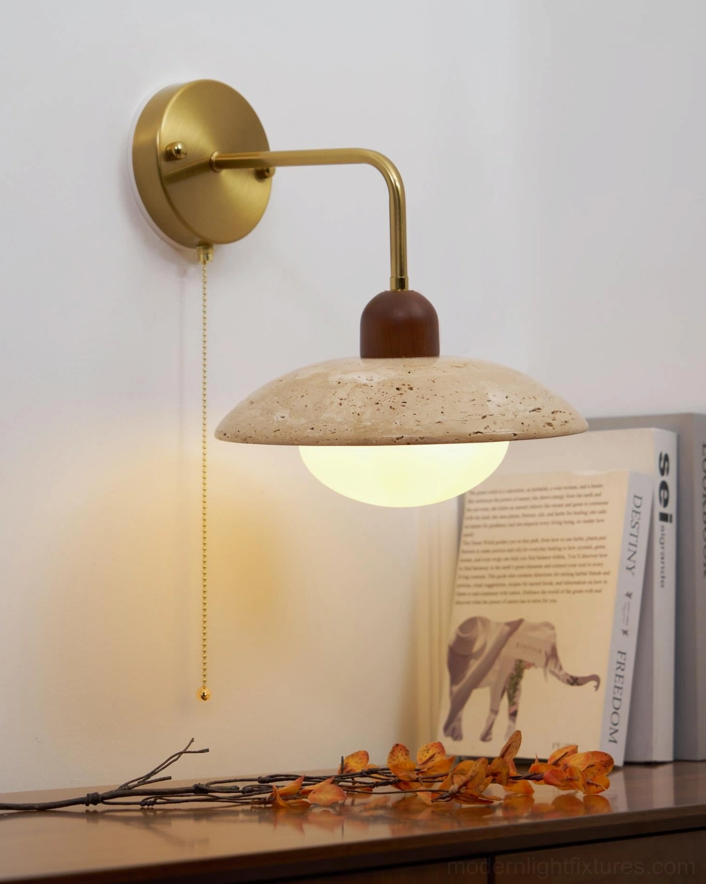 Modern travertine wall sconce details highlighting brass finish and architectural lighting design