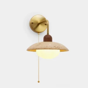 Modern travertine wall sconce with brass arm front view, speckled yellow stone shade with wood detail