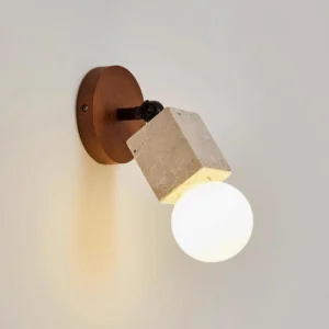 Modern travertine wall sconce front close-up showing warm ambient lighting and natural stone texture