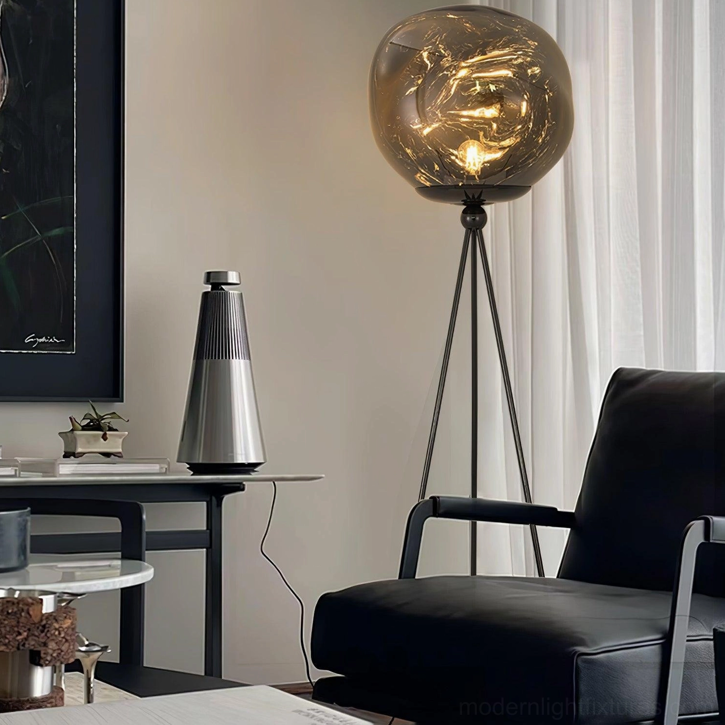 Modern tripod floor lamp with artistic molten glass and elegant three-legged metal stand structure