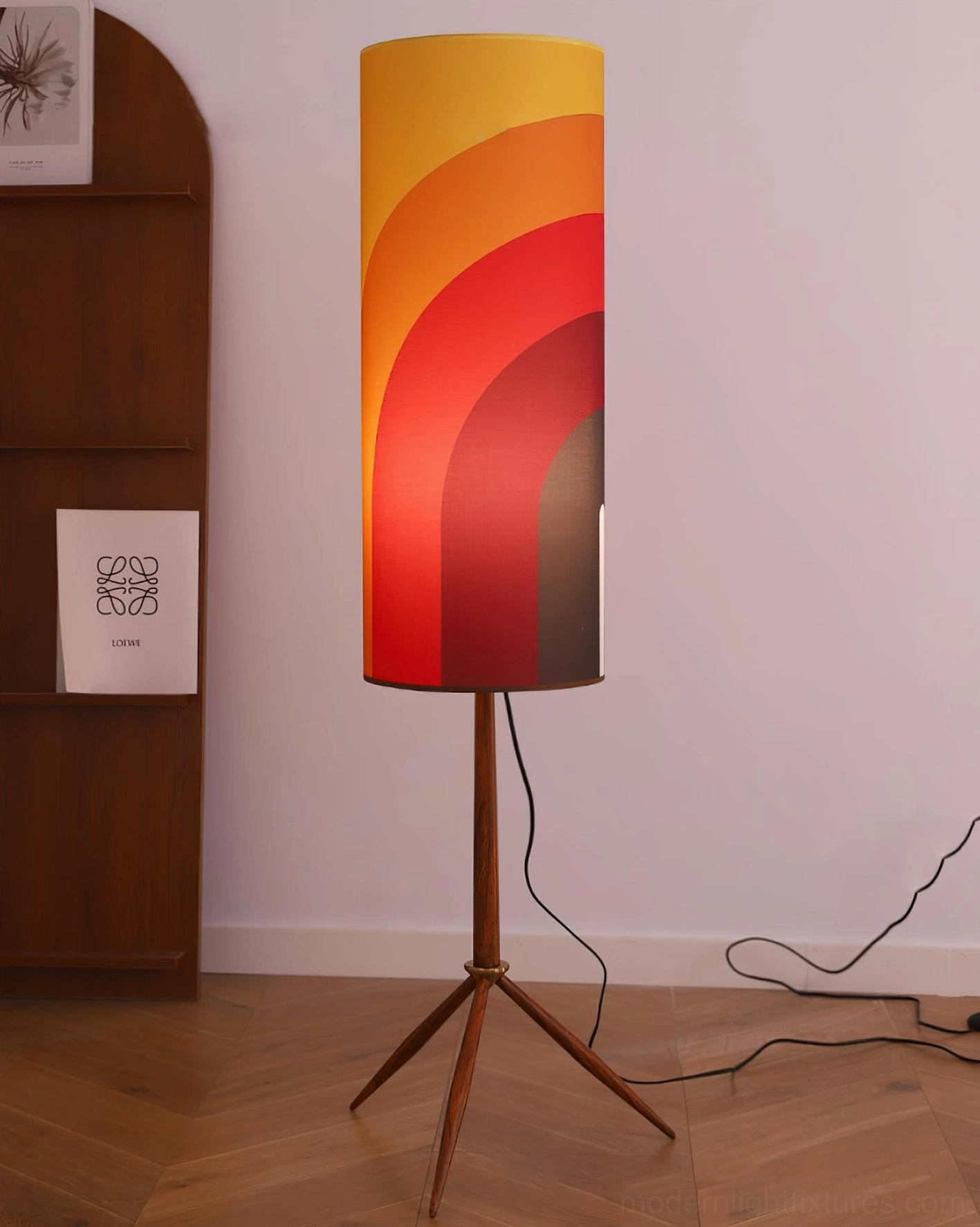 Modern tripod floor lamp with warm gradient shade and walnut wood base in minimalist interior corner, side view