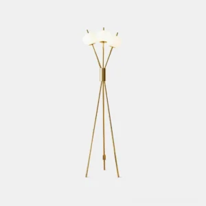Modern tripod floor lamp with three frosted white globe shades and gold metal frame, front view on white studio background