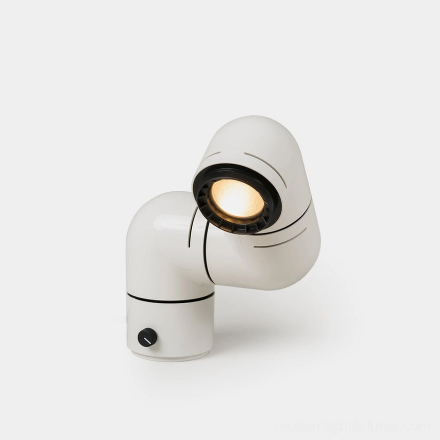 Industrial tubular table lamp front three-quarter view with matte white finish and black accents on studio background