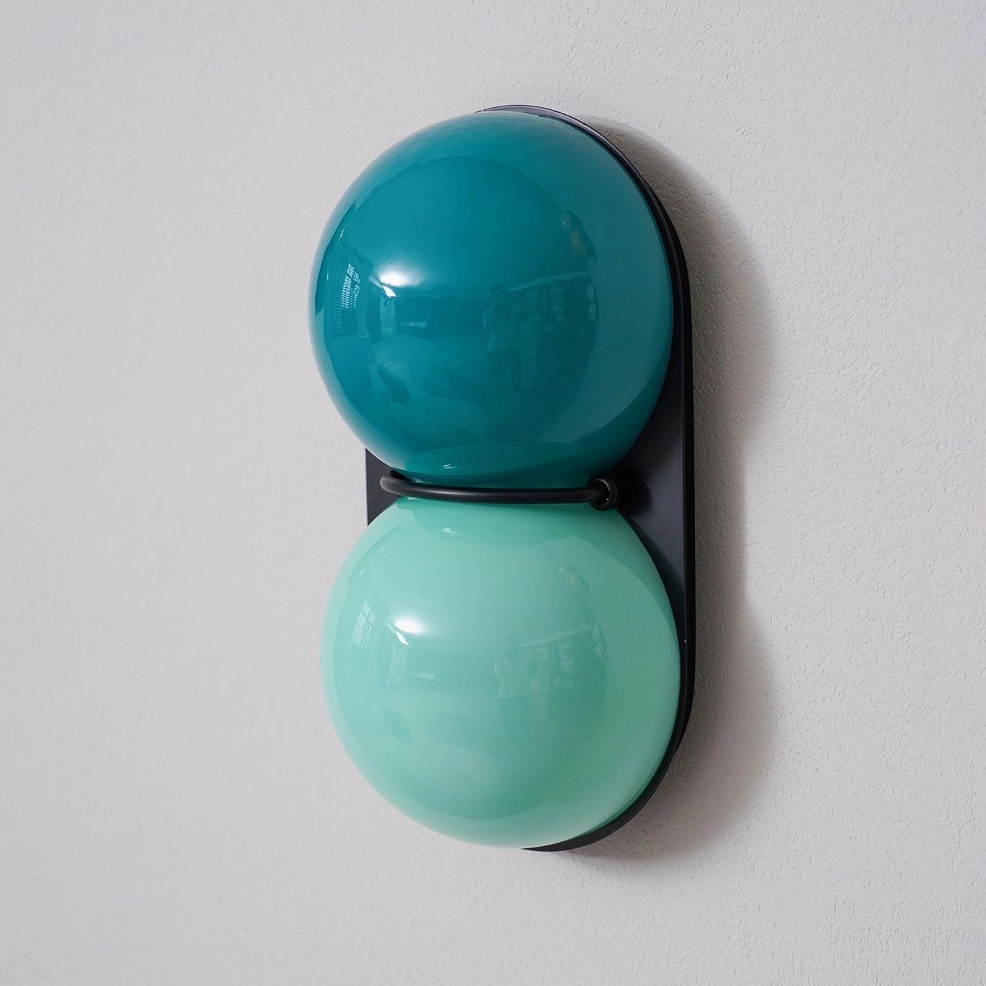 Modern Twinwave double globe wall sconce sculptural lighting in minimalist interior space