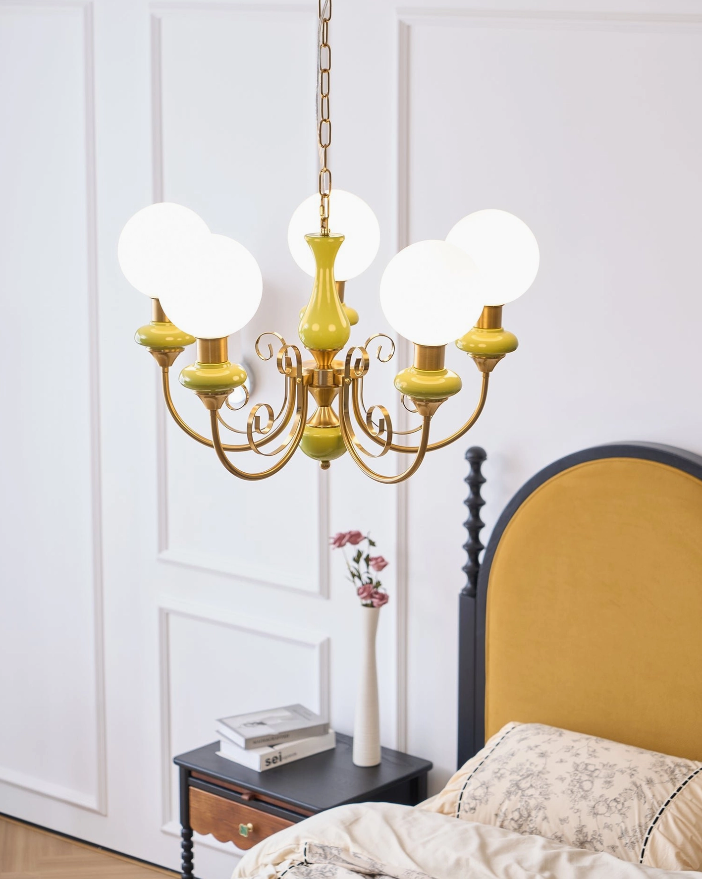 Modern vintage glass chandelier with swirling metallic frame, ambient lighting