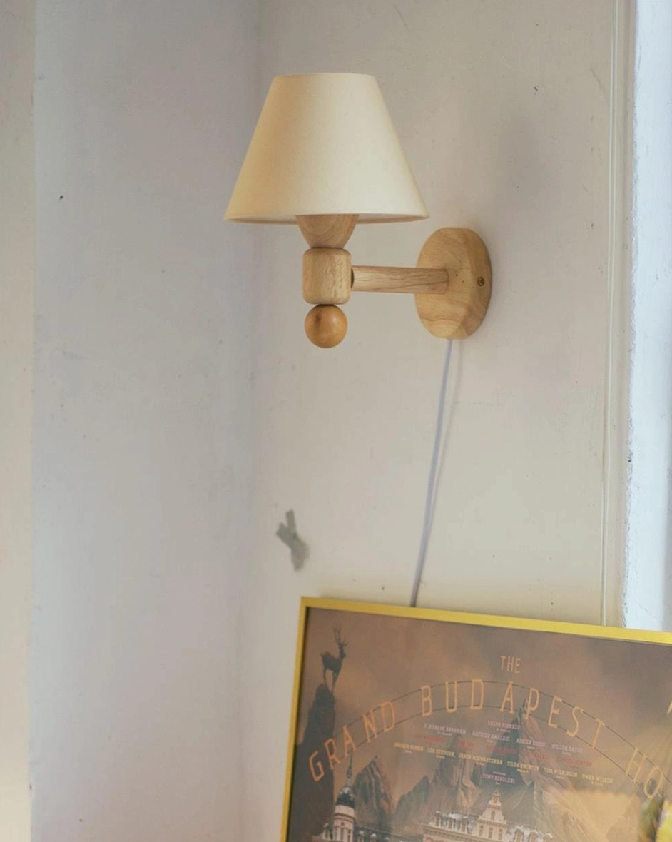 Contemporary hardwired wall lamp featuring bold orange conical shade and geometric wooden mounting bracket