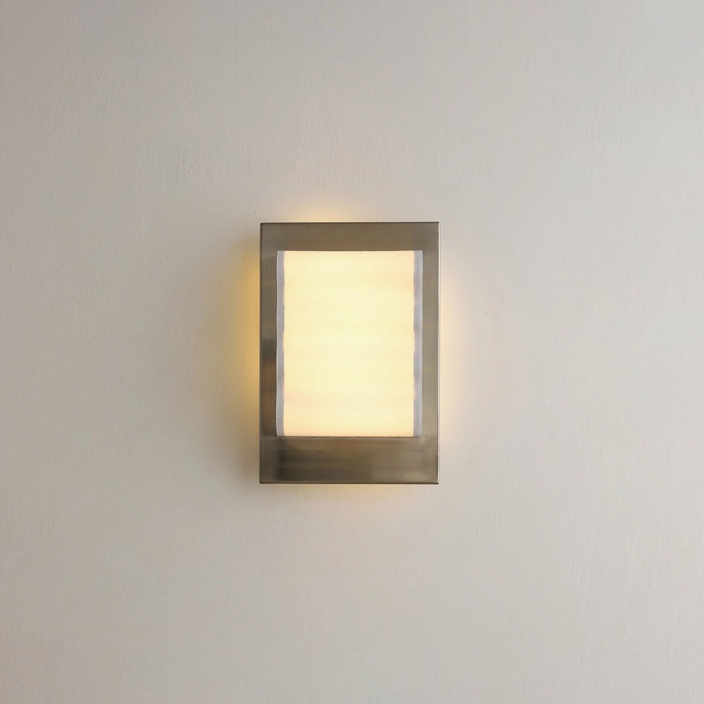 Rectangular modern wall lamp with brushed silver metal frame fully illuminated warm light output