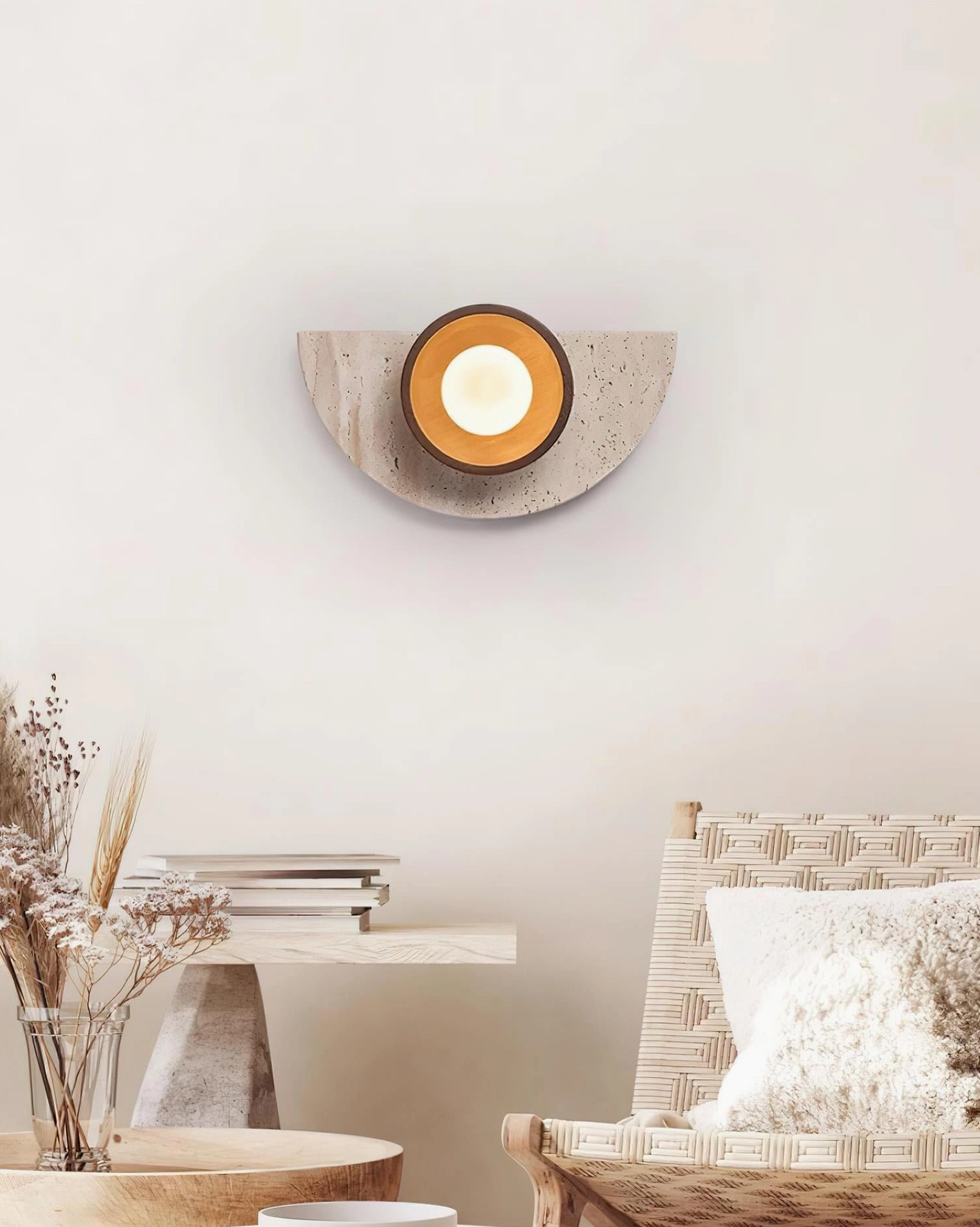 Semicircle wall lamp paired with woven furniture and dried flowers in bohemian minimalist sitting nook interior