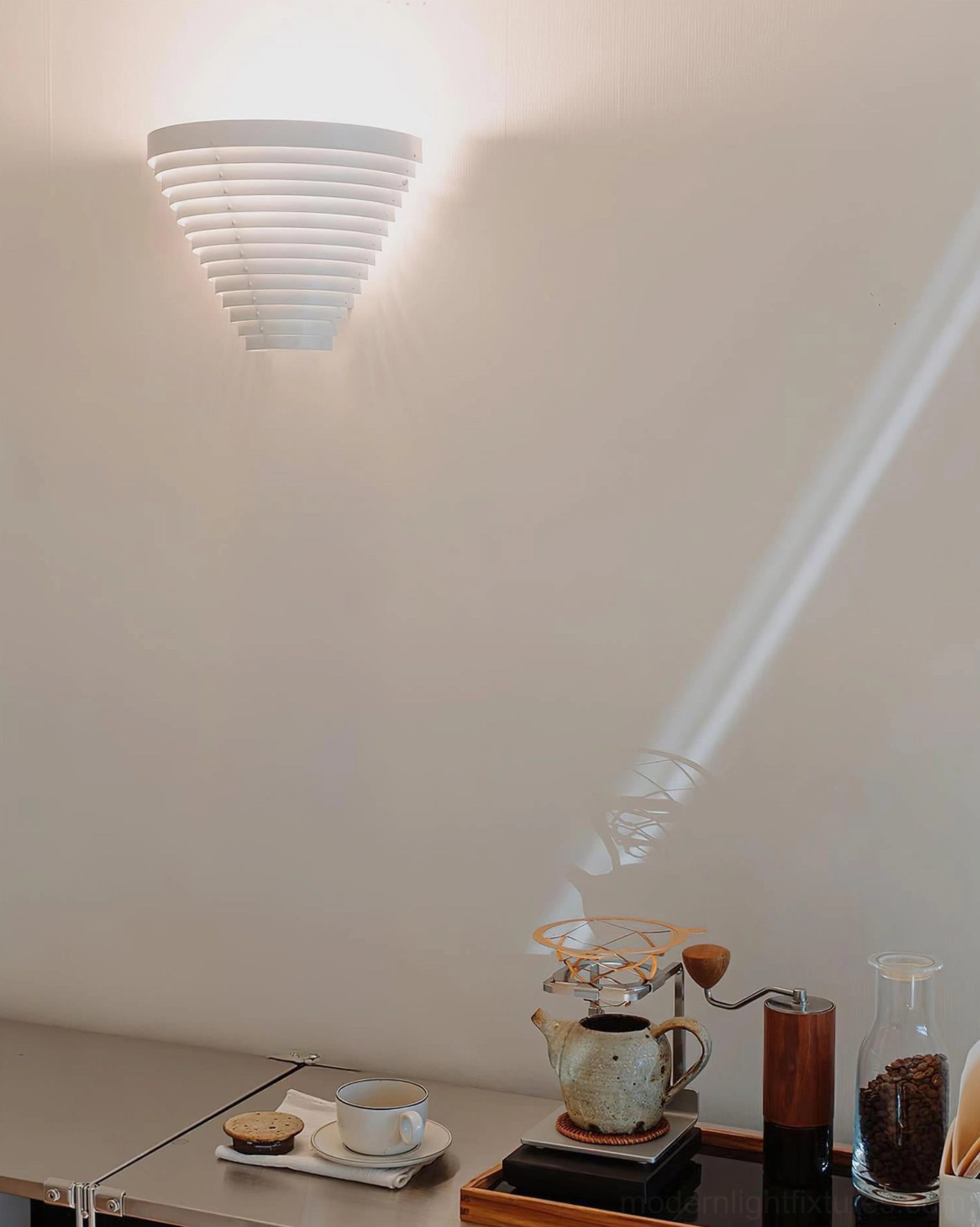 Contemporary louvered wall lamp installed above desktop area with angled light beam projection