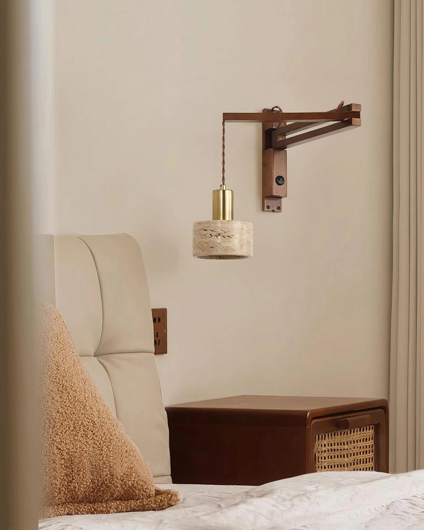 Minimalist swing arm wall lamp mounted on bedroom wall with leather upholstered headboard, compact modern sconce lighting